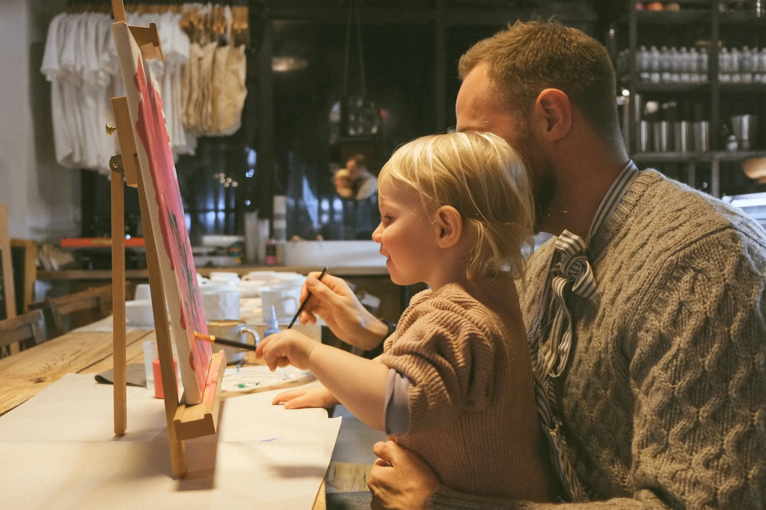 Father and daughter painting together at The Purple Owl